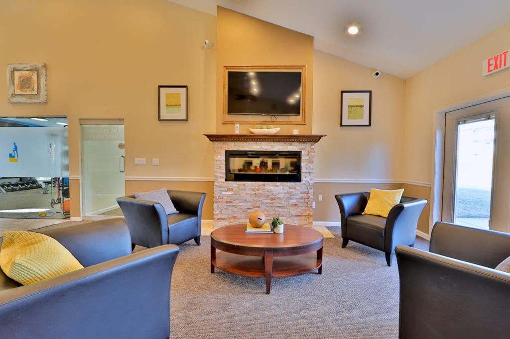 a living room with couches and chairs and a fireplace
