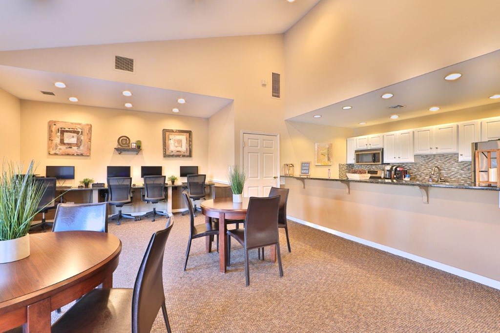 a dining room with a kitchen and a table and chairs
