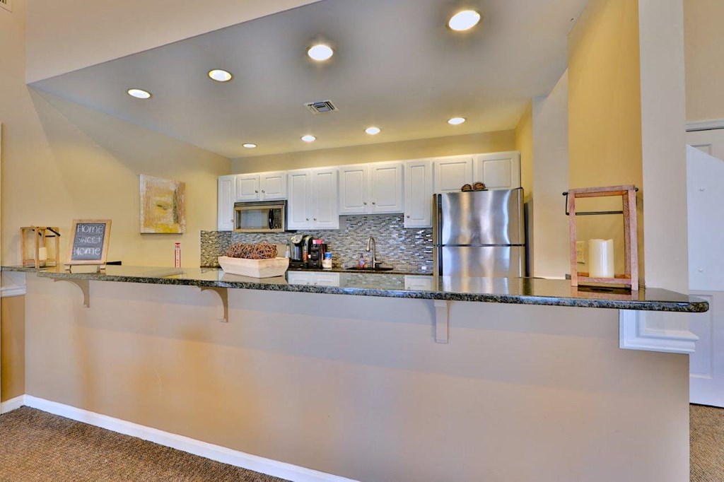 a kitchen with a counter top and a refrigerator