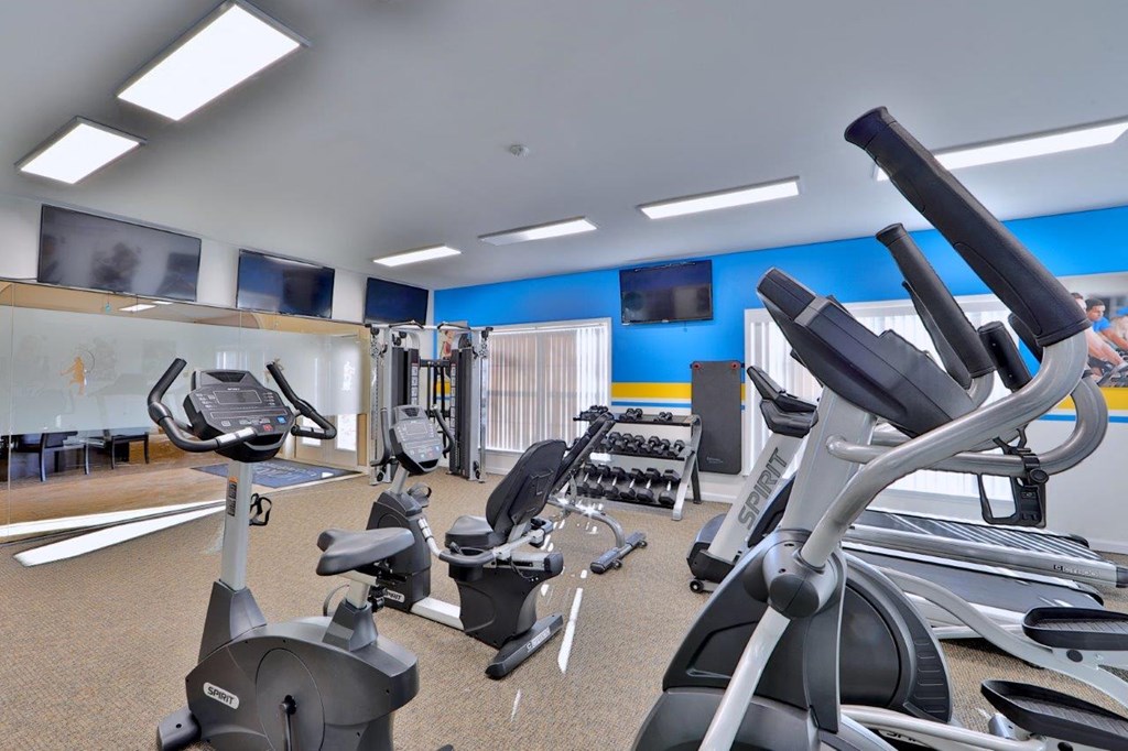 a gym with various pieces of exercise equipment
