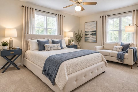 A bedroom with a large bed and a ceiling fan.