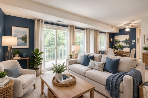 A living room with a sofa, armchair, and a coffee table.