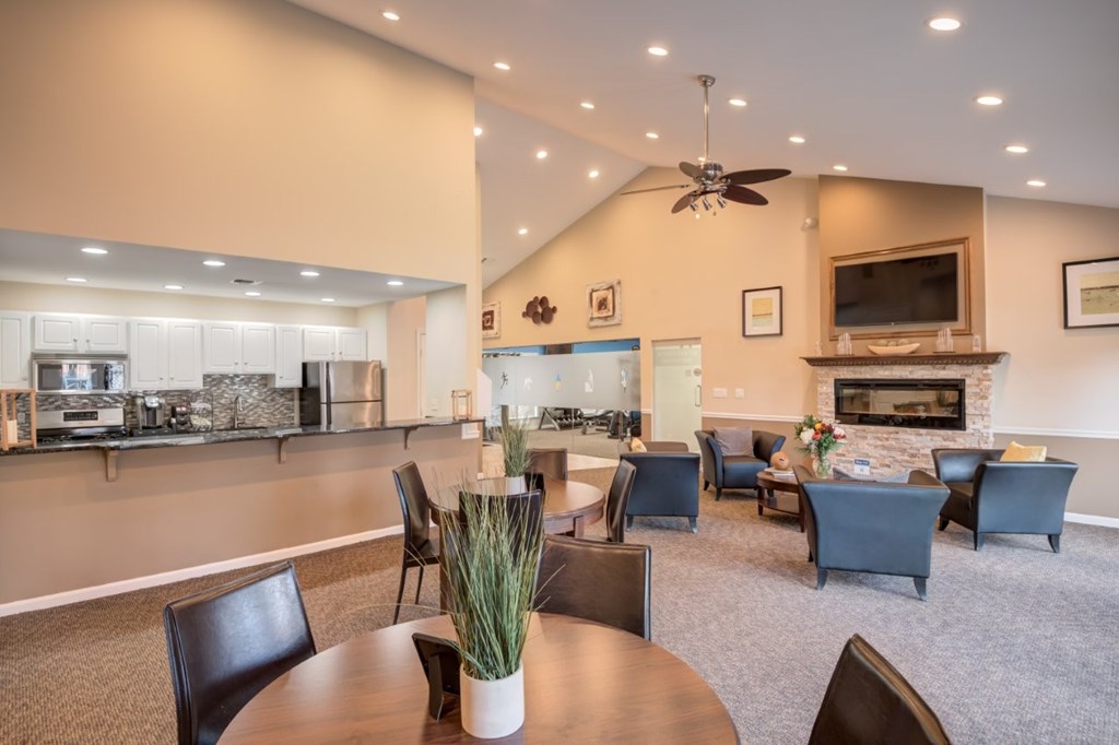 A living room with a fireplace and a dining table.