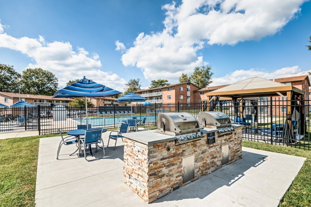 A sunny day at the outdoor seating area with blue umbrellas and a stone counter.