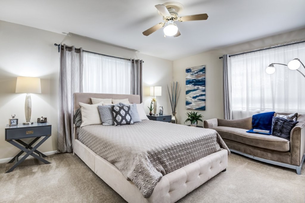 A bedroom with a large bed and a couch.