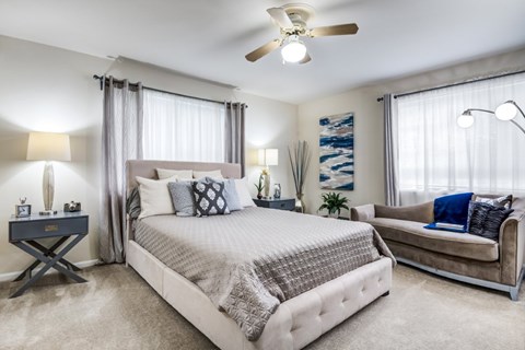 A bedroom with a large bed and a couch.