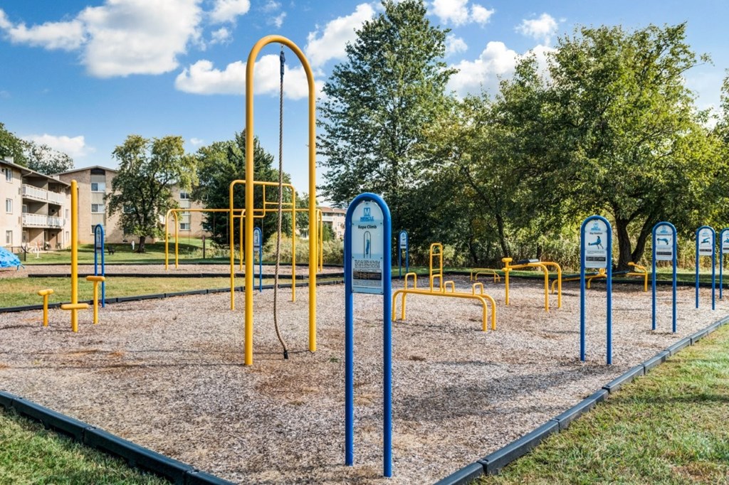 A playground with yellow and blue equipment.