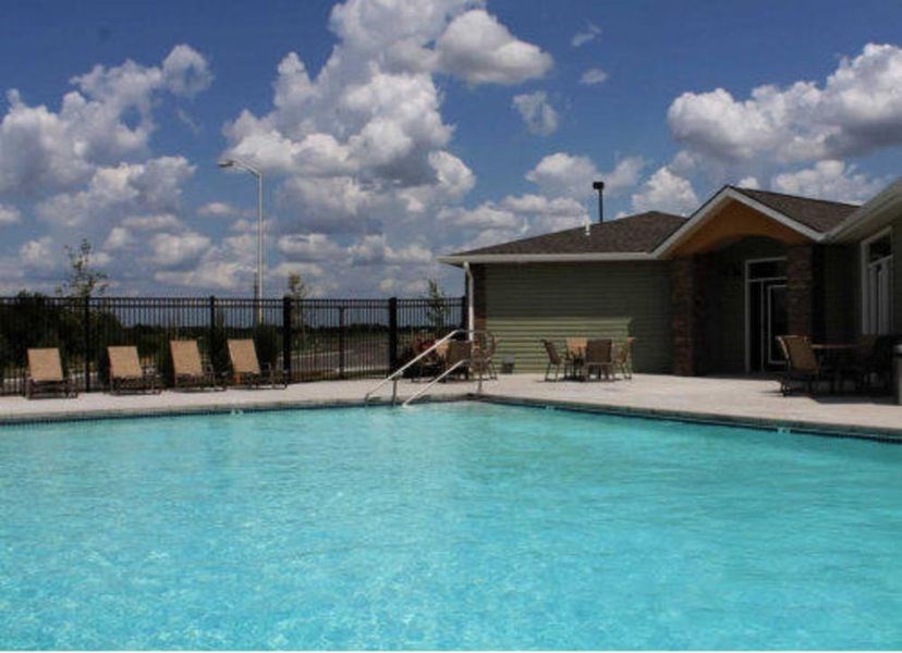 Salt Water Resort Style Pool a swimming pool with chairs and a house