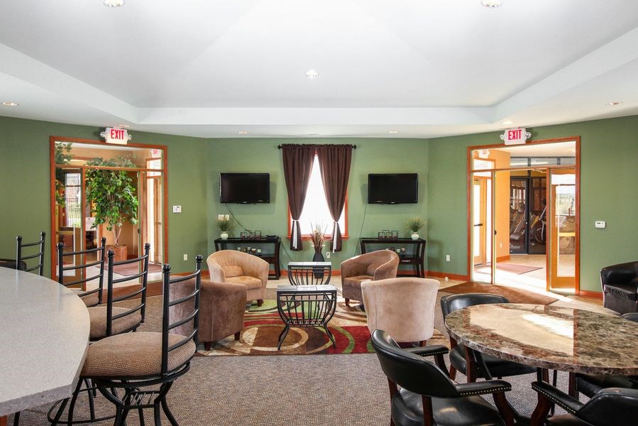 a living room with a table and chairs