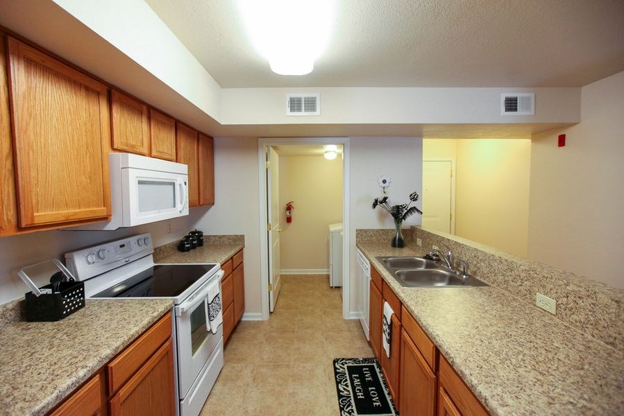 a kitchen with granite counter tops and white appliances