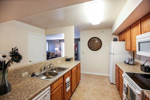 a kitchen with a sink and a refrigerator