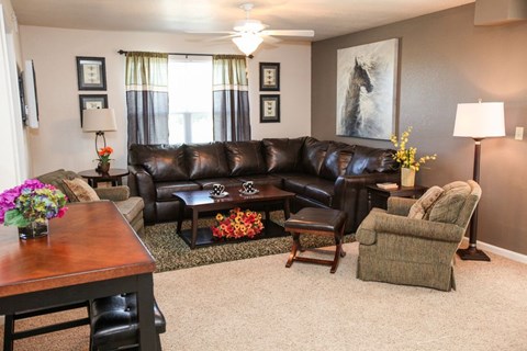 a living room with a leather couch and a table