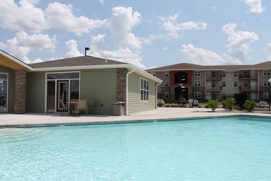 a swimming pool in front of an apartment building