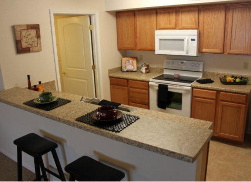 a kitchen with an island and a stove and a microwave