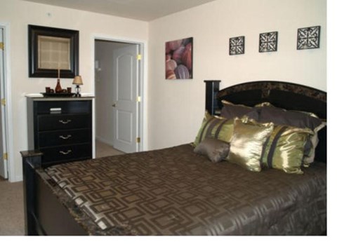 a bedroom with a bed and a dresser