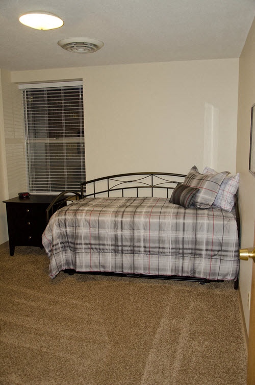 a bedroom with a bed and a window