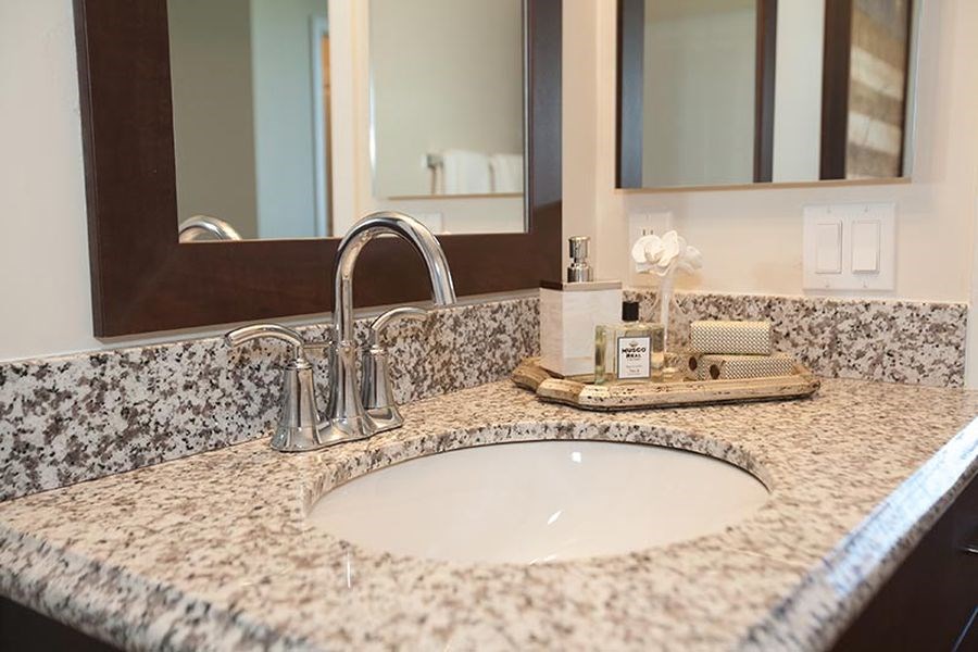 a bathroom counter with a sink and a mirror