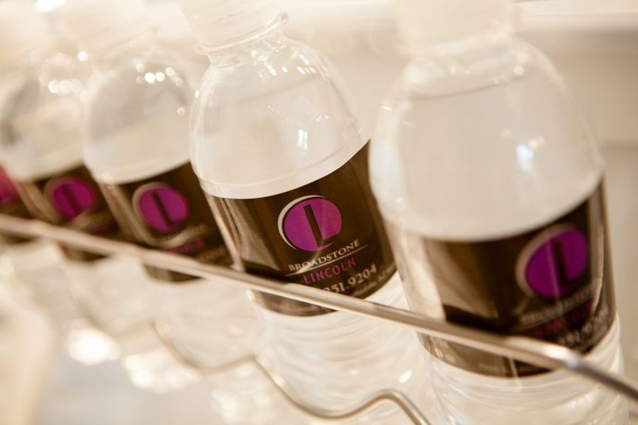 a group of bottles of water on a tray