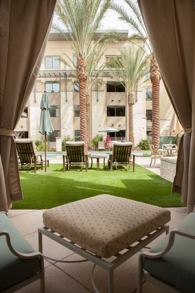 a seating area with a table and chairs in a courtyard