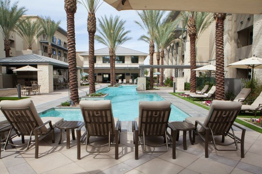 a swimming pool with chairs and umbrellas at the resort