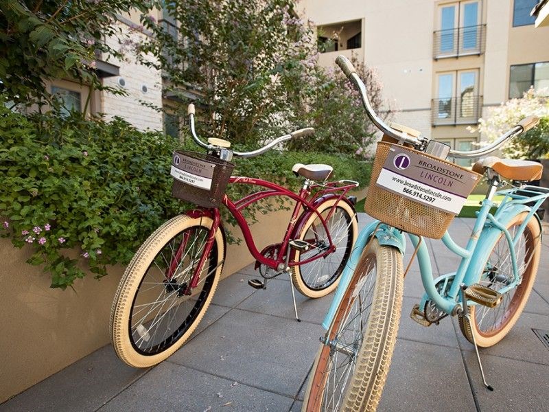 two bikes parked next to each other on a sidewalk