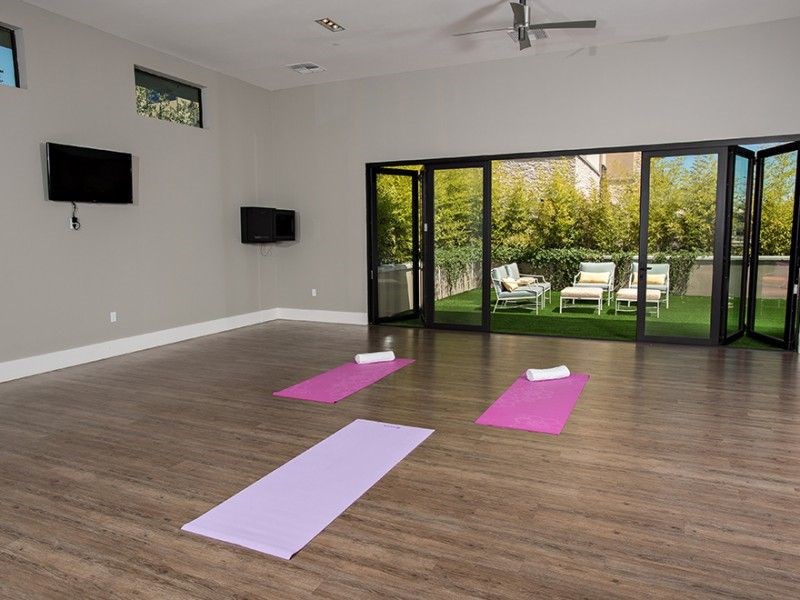 a room with several yoga mats on the floor