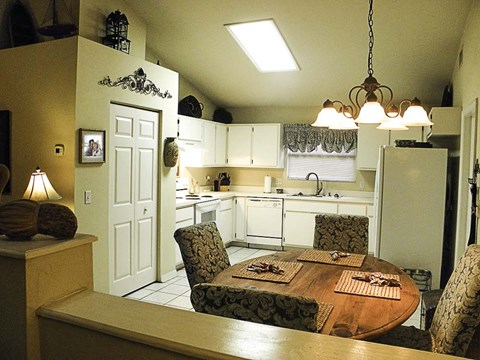 a kitchen and dining room with a table and chairs