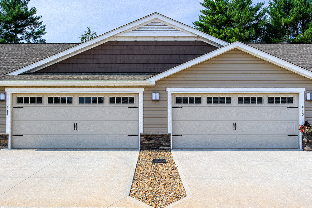 A two-car garage with a brown roof and white trim.