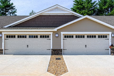 A two-car garage with a brown roof and white trim.