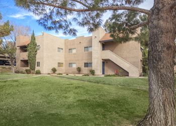 the exterior of a building with a green lawn and trees at Desert Bay Apartments, Laughlin, Nevada, 89029