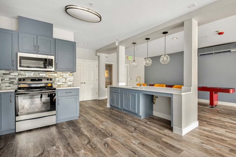 a kitchen with stainless steel appliances and blue cabinets