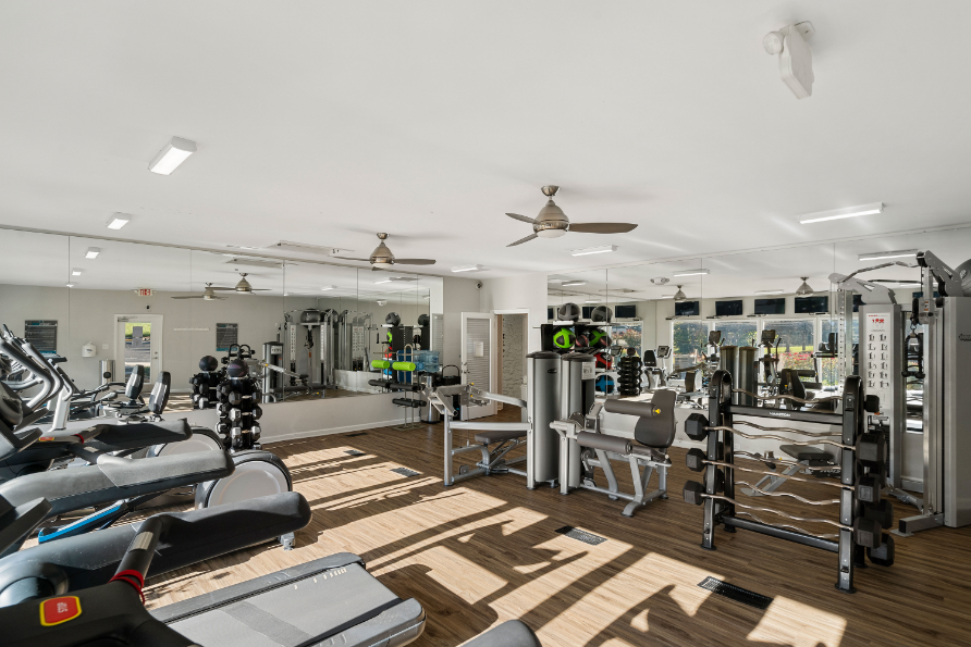 Amenities Highlight Large Fitness Center with Cardio and Weight Training Equipment