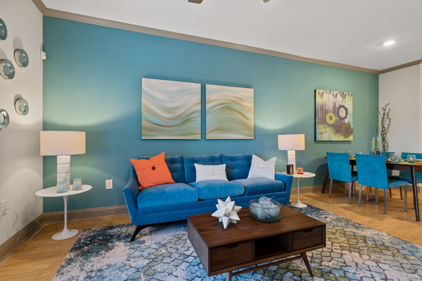 a living room with a blue couch and a coffee table