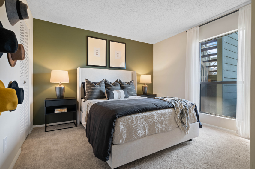 a bedroom with a bed and a large window