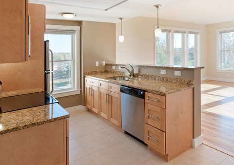 a large kitchen with granite counter tops and stainless steel appliances