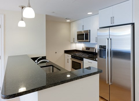 a kitchen with stainless steel appliances and a counter top