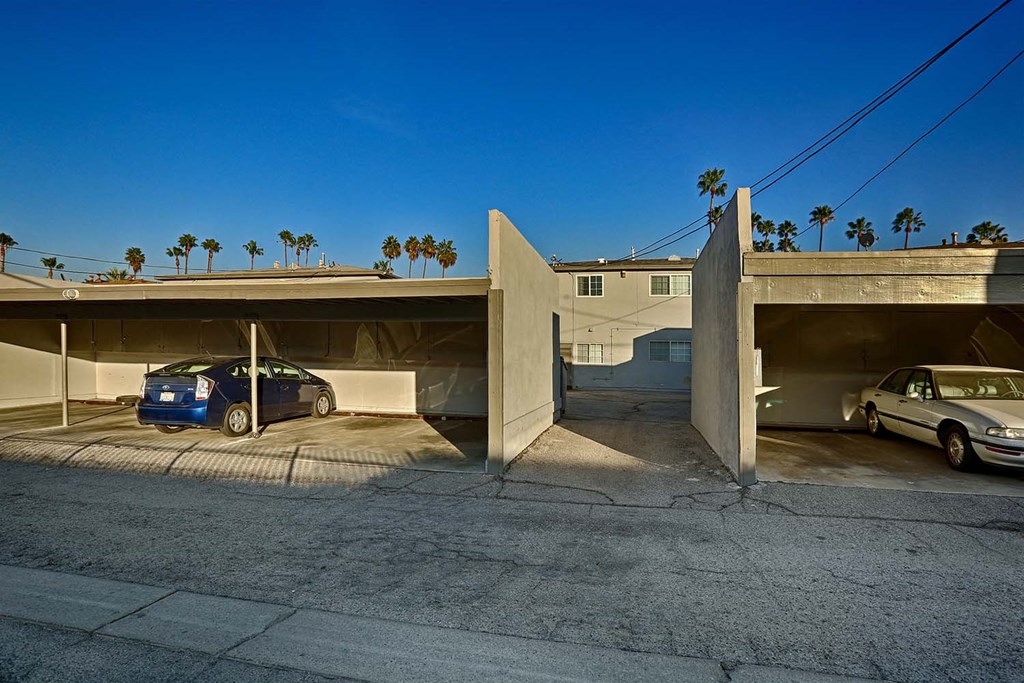 a parking garage with cars parked under it
