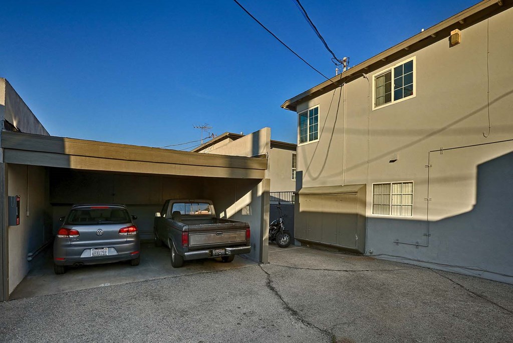 a garage with two cars parked in it