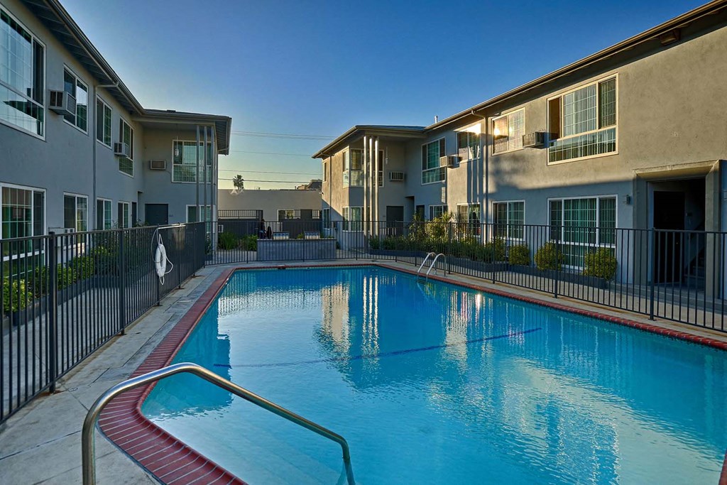 a large swimming pool in front of some apartment buildings
