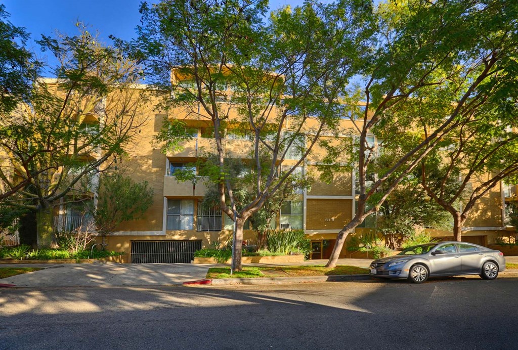 a car parked in front of an apartment building