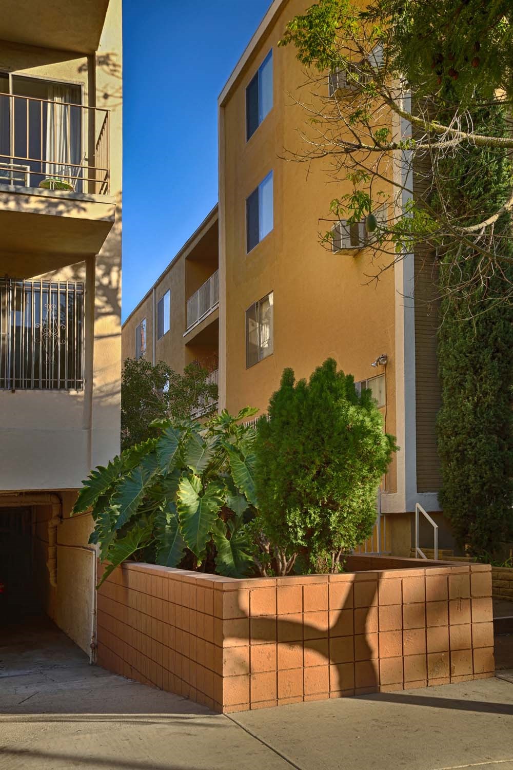 a large brick planter in front of a building