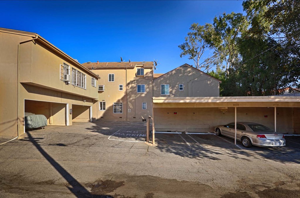 a parking lot with a car in front of a building