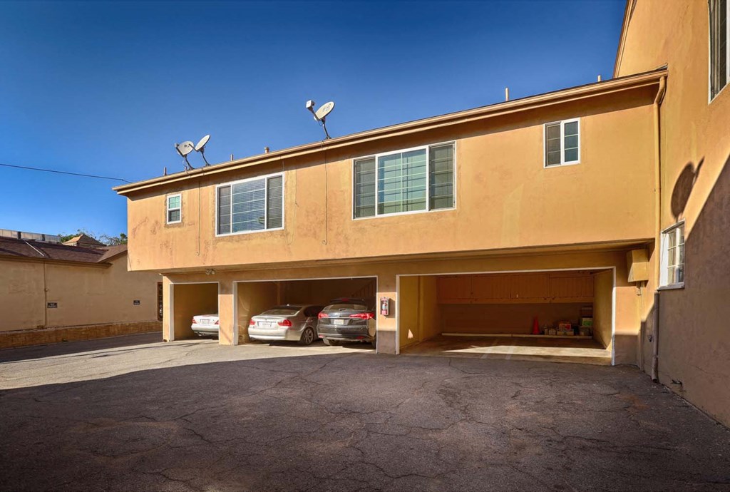 a parking garage with two cars in it