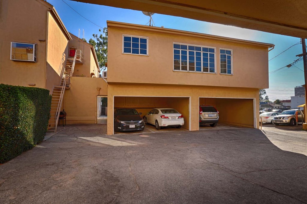 a garage with two cars parked in it