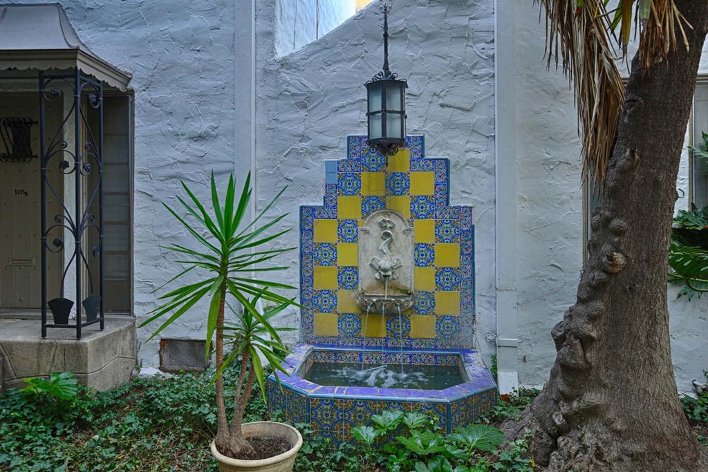 a small fountain in the courtyard of a building
