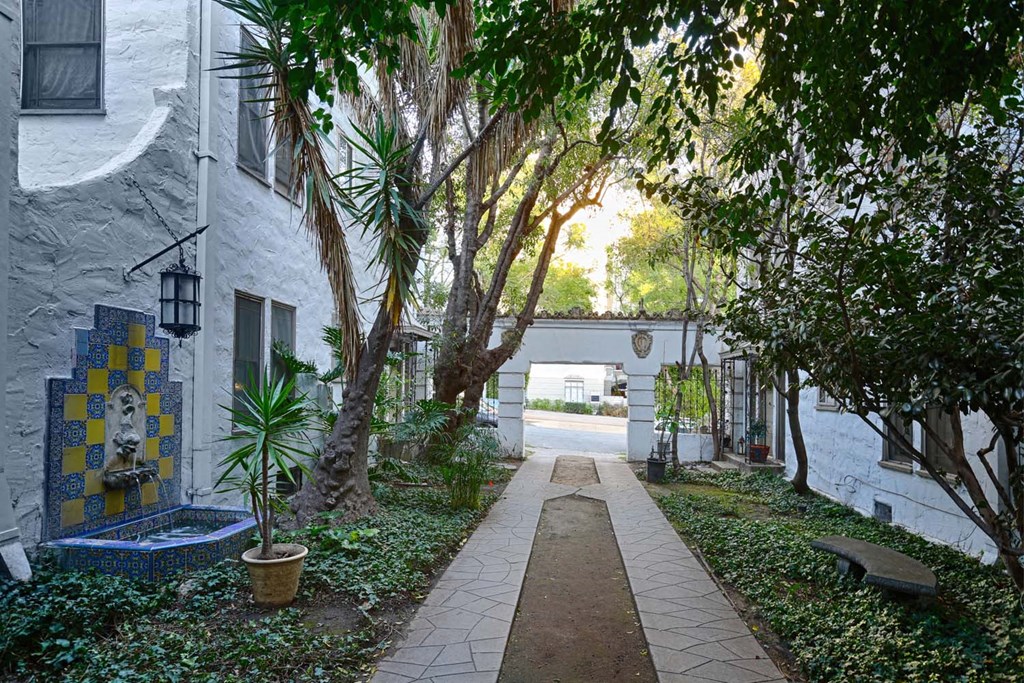 the courtyard of a building with trees and a walkway