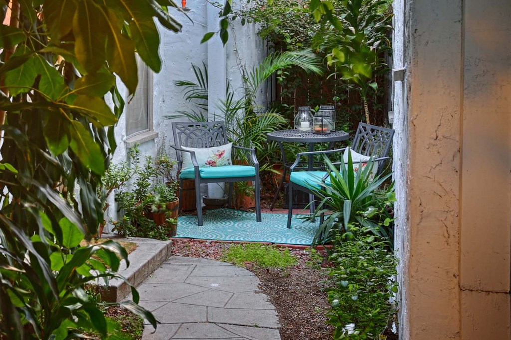 a small courtyard with two chairs and a table