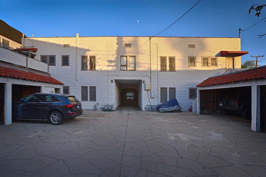 a white building with a car parked in front of it