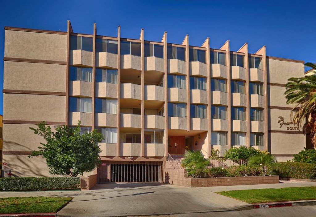 a building with many windows and a street in front of it