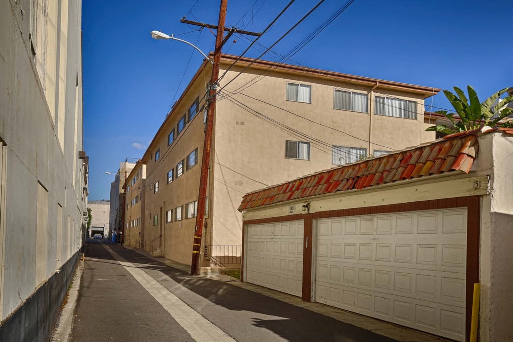 a city street with a building and a garage door